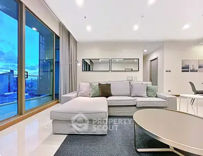 Spacious modern living room with large windows and city view, perfect for urban living.