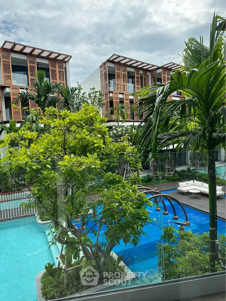 Luxurious residential complex with stunning pool and lush greenery, offering a serene and upscale living environment.