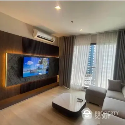 Modern living room with sleek design, featuring a wall-mounted TV and large window with city view.