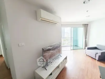 Modern living room with air conditioning and balcony view in a stylish apartment.