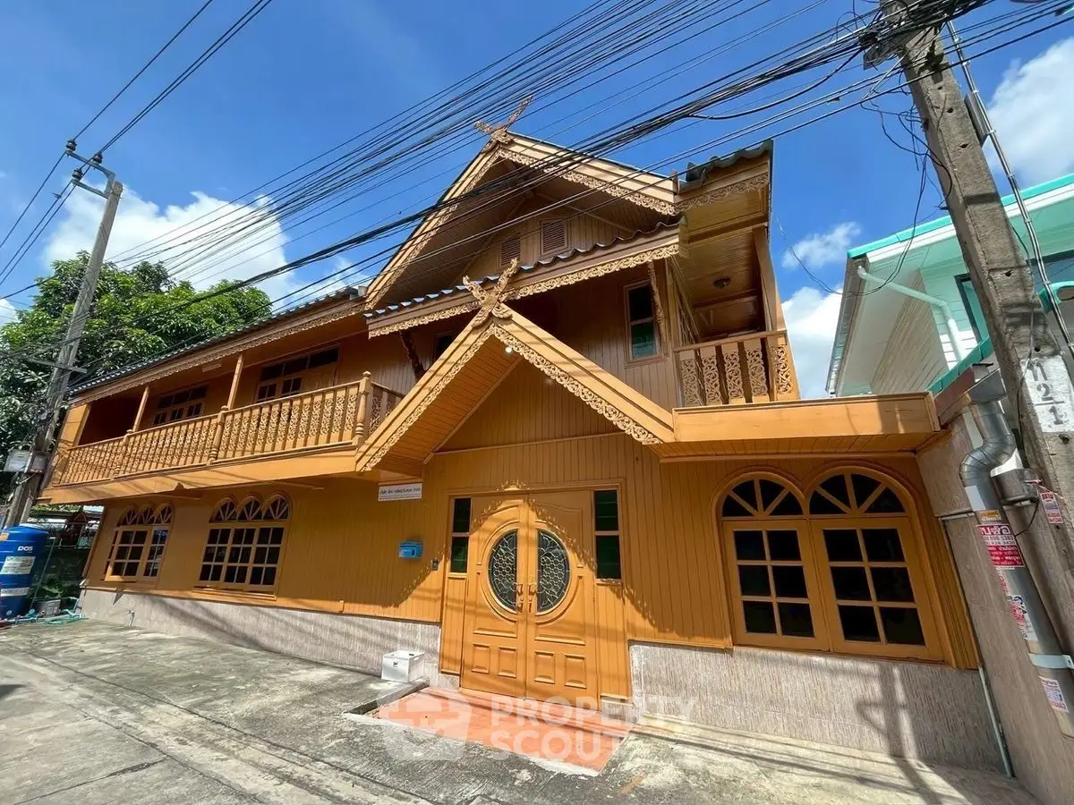Charming traditional wooden house with intricate design and spacious balcony in a serene neighborhood.