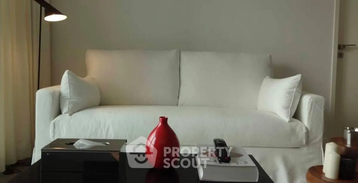 Elegant living room with white sofa and modern decor, perfect for relaxation and style.