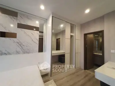 Modern bedroom with stylish decor and mirrored closet doors