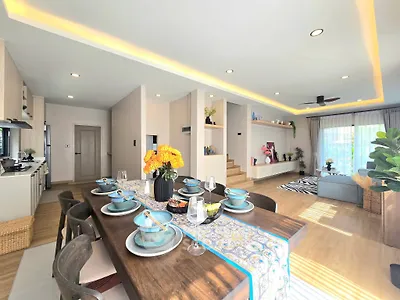 Spacious modern living room with dining area, open layout, and stylish decor