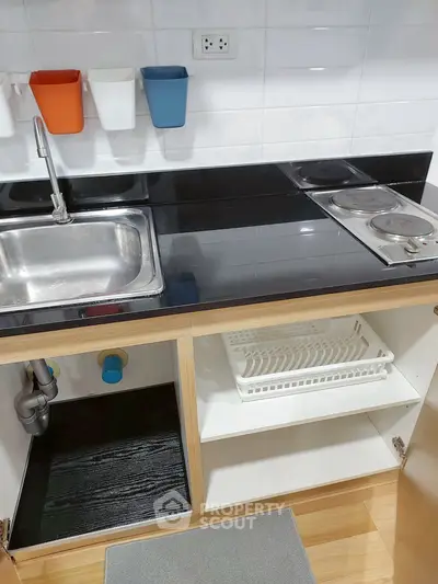 Modern kitchen with sleek black countertop and stainless steel sink