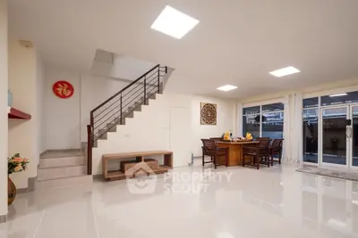 Spacious modern living room with elegant dining area and staircase