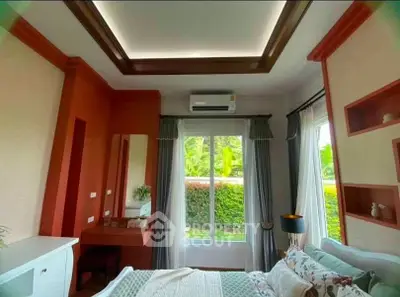 Charming bedroom with garden view, featuring elegant ceiling design and cozy decor.