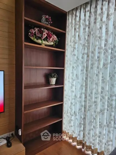 Elegant wooden bookshelf with floral decor in a cozy living room setting