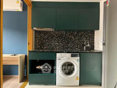 Modern kitchen with sleek cabinetry and built-in washing machine