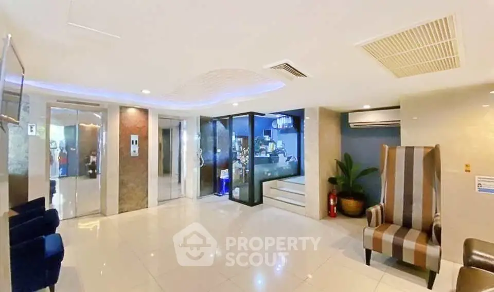 Luxurious building lobby with modern design and elegant seating area.