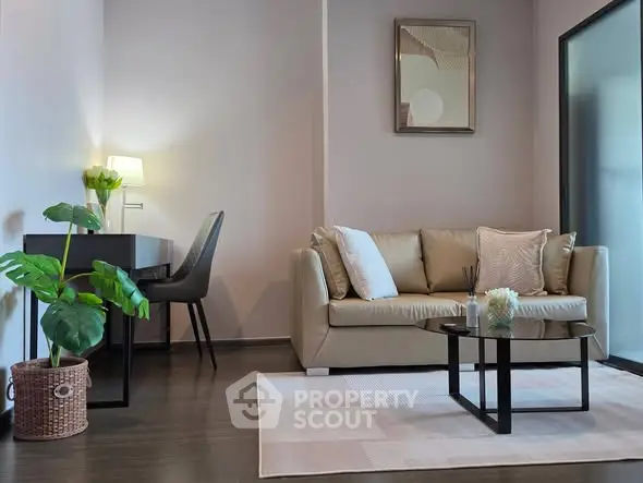 Modern living room with stylish sofa, desk, and decor in a cozy apartment setting.