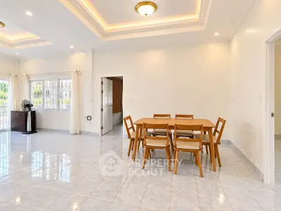 Spacious dining area with elegant wooden furniture and bright natural lighting