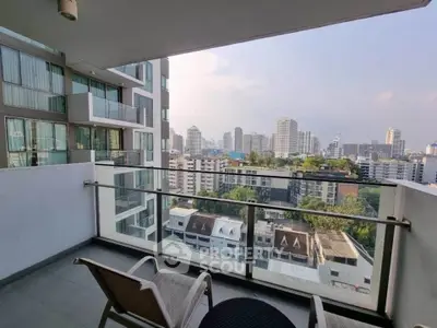 Spacious balcony with stunning city view in modern high-rise apartment.