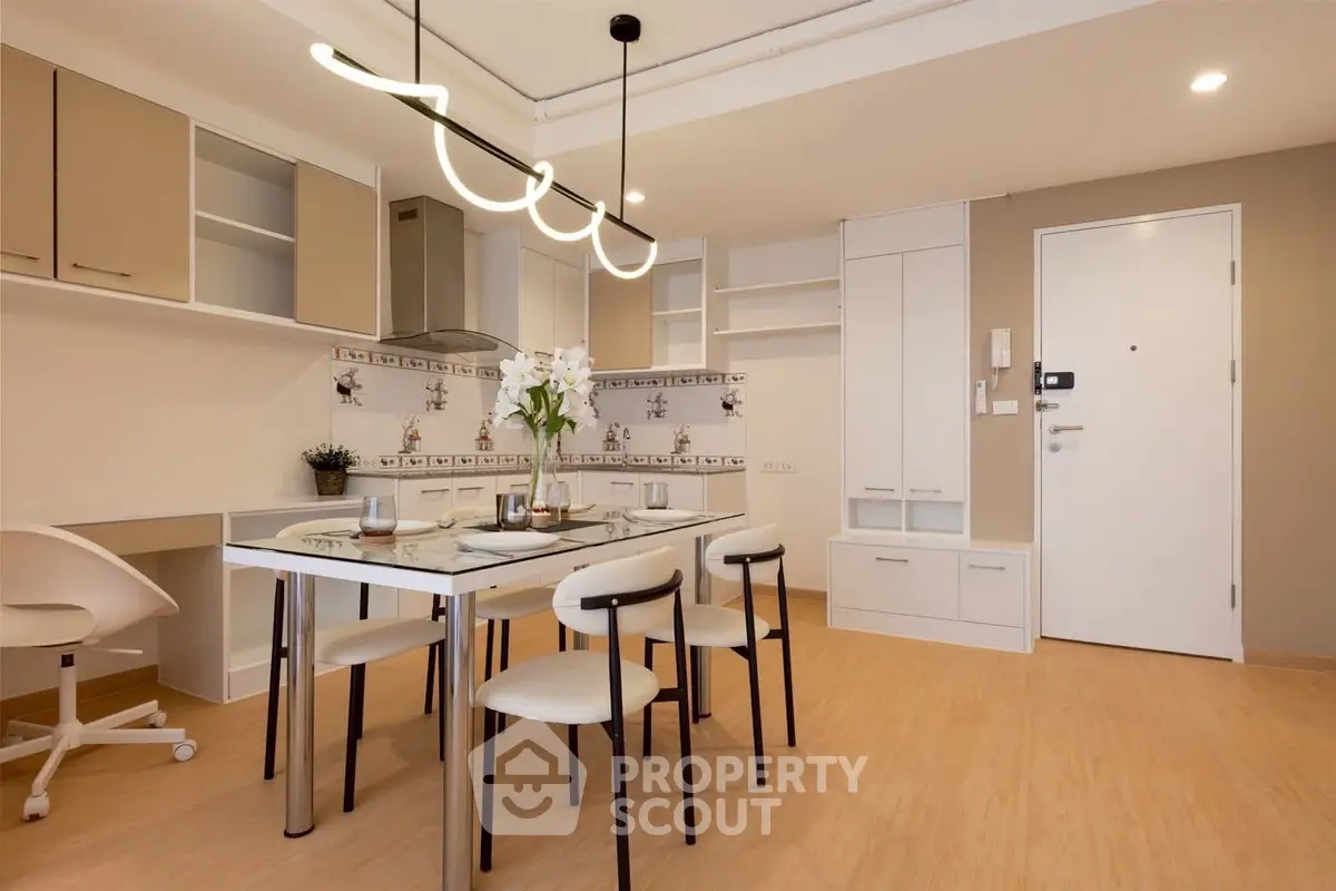 Modern dining area with stylish lighting and elegant decor in a contemporary apartment.