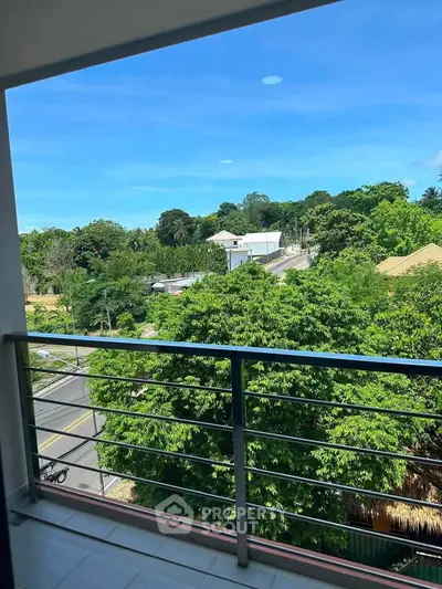 Spacious balcony with stunning green view in a serene neighborhood.