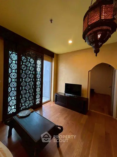 Elegant living room with intricate wooden decor and warm lighting, perfect for cozy evenings.