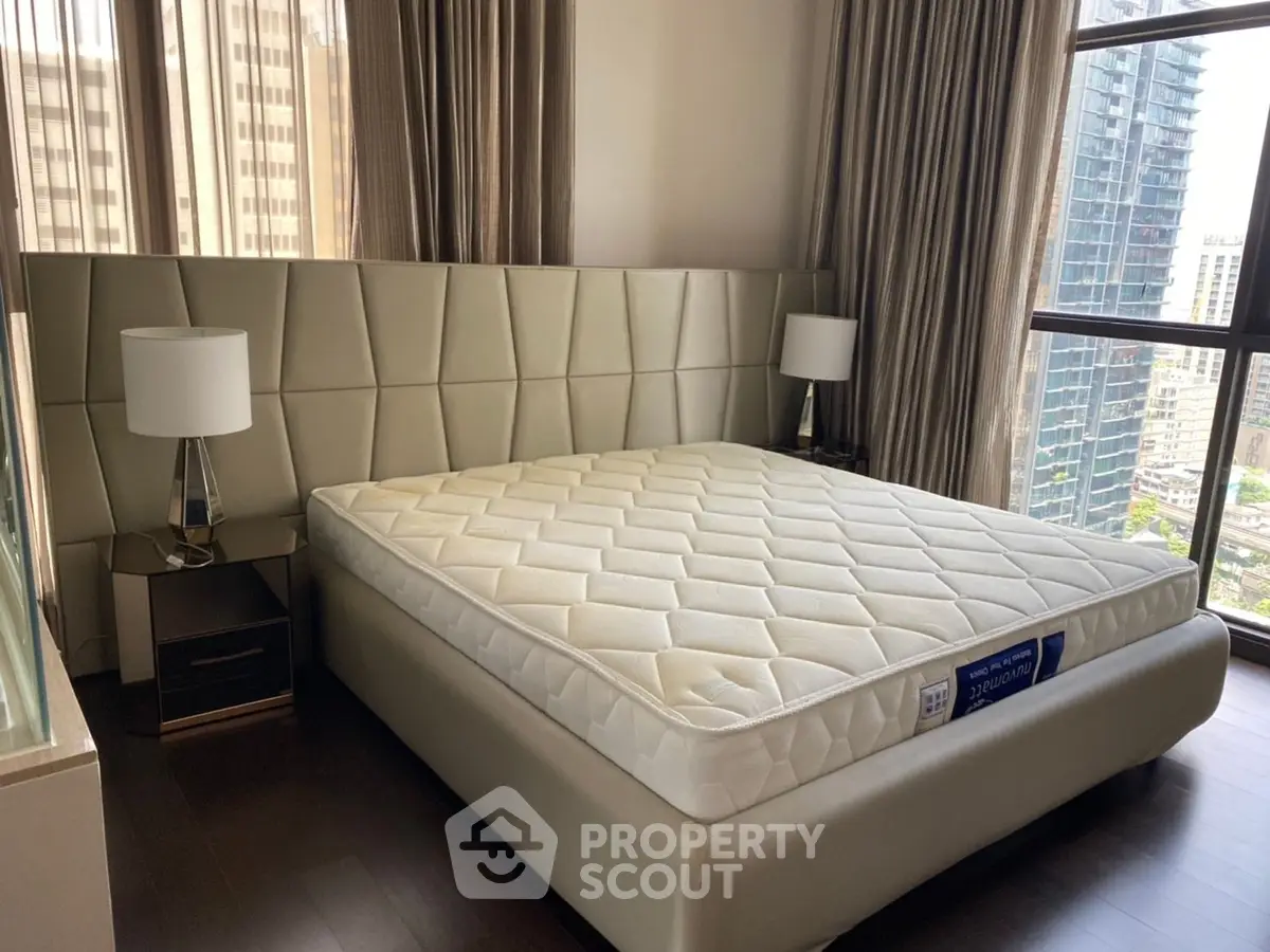 Luxurious bedroom with modern design and city view, featuring a stylish bed and elegant decor.