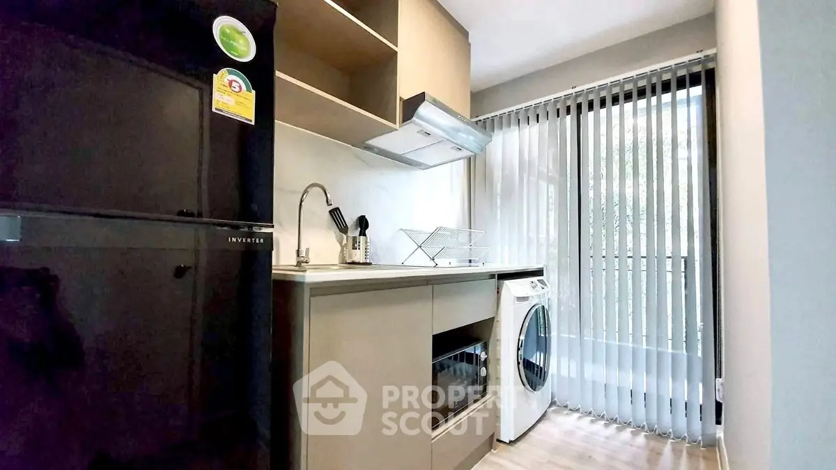 Modern kitchen with sleek appliances and natural light
