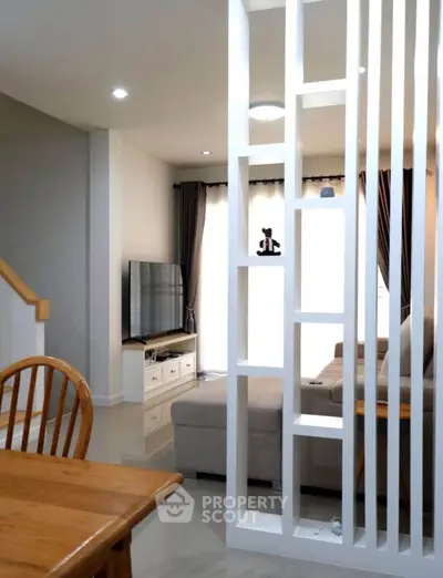 Modern living room with stylish partition and cozy seating area