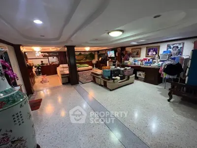 Spacious living room with unique ceiling design and cozy seating area