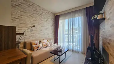 Charming living room with modern decor and large window for natural light.