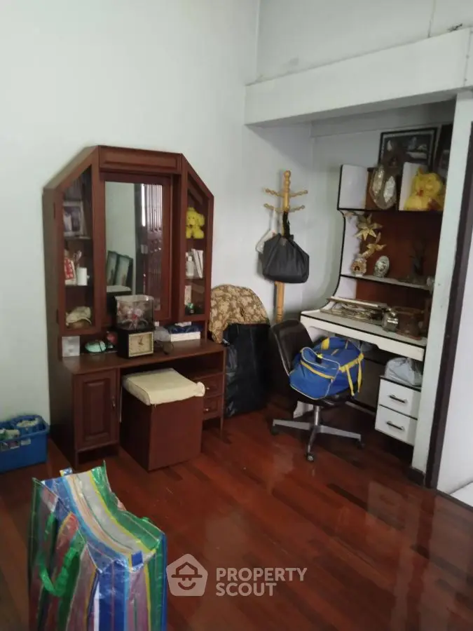 Cozy study room with wooden flooring and ample storage space