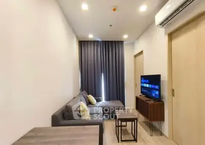 Modern living room with cozy sofa and wall-mounted TV, perfect for relaxation.