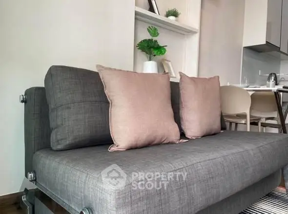 Modern living room with stylish gray sofa and cozy cushions