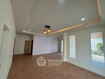 Spacious modern living room with elegant lighting and wooden flooring