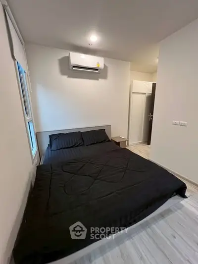 Modern bedroom with sleek design and air conditioning unit, perfect for comfort and relaxation.
