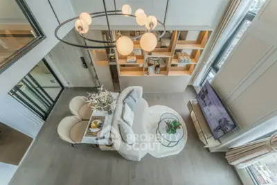 Luxurious modern living room with elegant decor and large windows offering stunning city views.