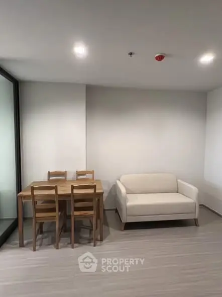 Modern minimalist living room with cozy sofa and dining table