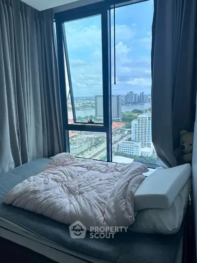 Cozy bedroom with stunning city view from high-rise window