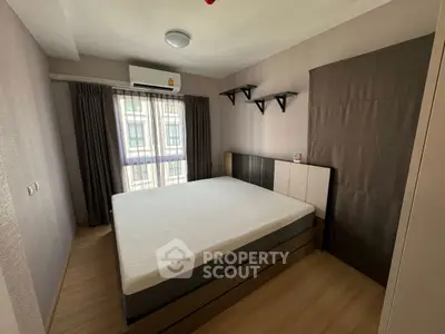 Modern bedroom with natural light and minimalist design, featuring a comfortable bed and stylish shelves.