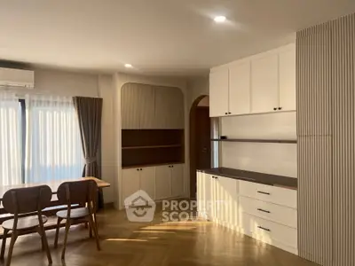 Spacious dining area with elegant built-in cabinetry and natural light.