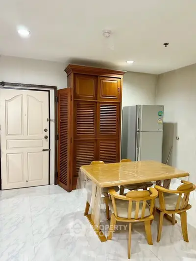 Spacious kitchen with wooden dining set and modern appliances