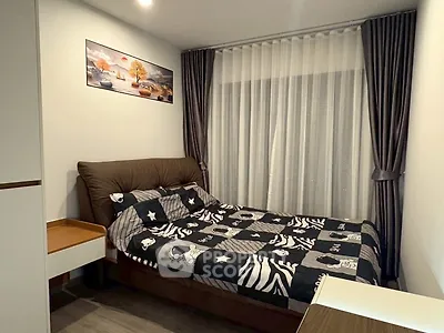 Cozy bedroom with stylish decor and natural light, perfect for relaxation and comfort.