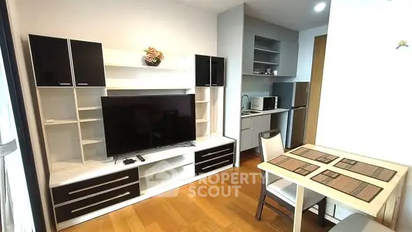 Modern living room with sleek entertainment center and dining area