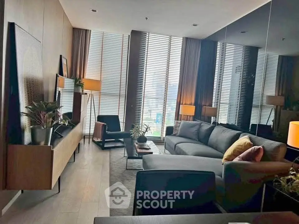 Luxurious modern living room with stylish decor and large windows offering natural light.