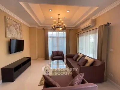 Elegant living room with modern chandelier and cozy seating area