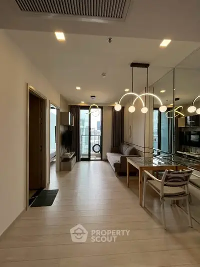 Modern living room with stylish lighting and city view from balcony