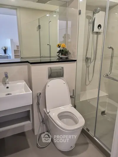Modern bathroom with sleek fixtures and glass shower enclosure