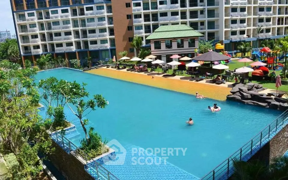 Luxurious condominium with expansive pool and vibrant outdoor amenities.