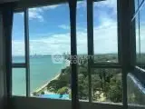 Stunning ocean view from high-rise apartment window, perfect for serene living.