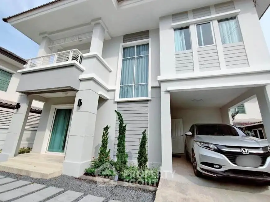 Modern two-story house with attached garage and landscaped front yard.