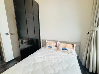 Modern bedroom with sleek wardrobe and cozy bed in a stylish apartment.