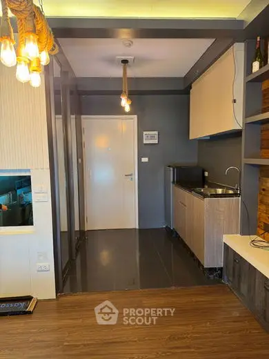 Modern compact kitchen with sleek cabinetry and ambient lighting