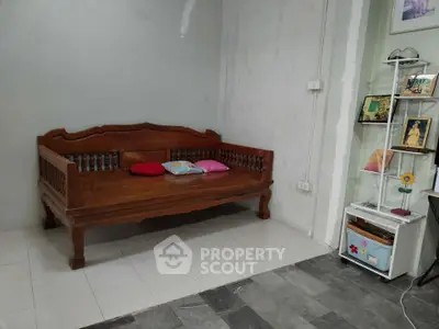 Cozy living room corner with wooden bench and decorative shelf