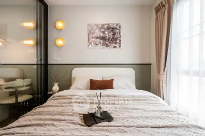 Cozy bedroom with elegant decor and natural light, featuring a comfortable bed and stylish wall art.