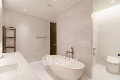 Luxurious modern bathroom with freestanding bathtub and elegant fixtures.